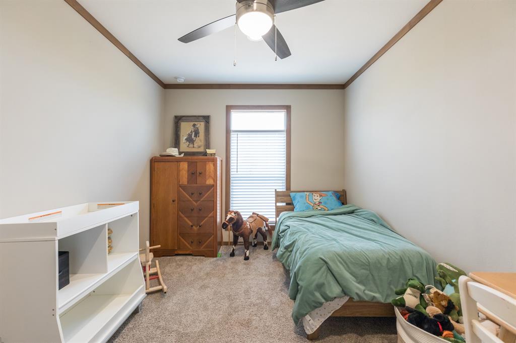 10099 County Road 452 Merkel, TX 79536 - Photo 20 of 28 a bed sitting in a room next to a window