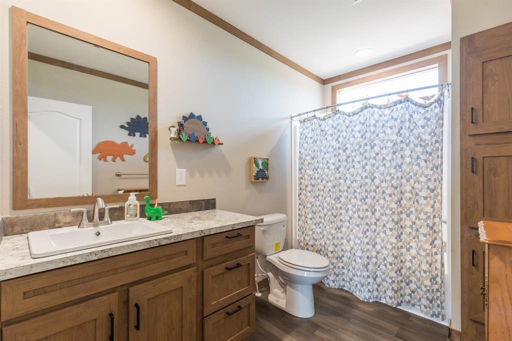 10099 County Road 452 Merkel, TX 79536 - Photo 22 of 28 a bathroom with a double vanity sink toilet and shower
