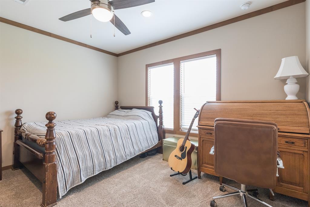 10099 County Road 452 Merkel, TX 79536 - Photo 23 of 28 a bedroom with a bed and a chandelier