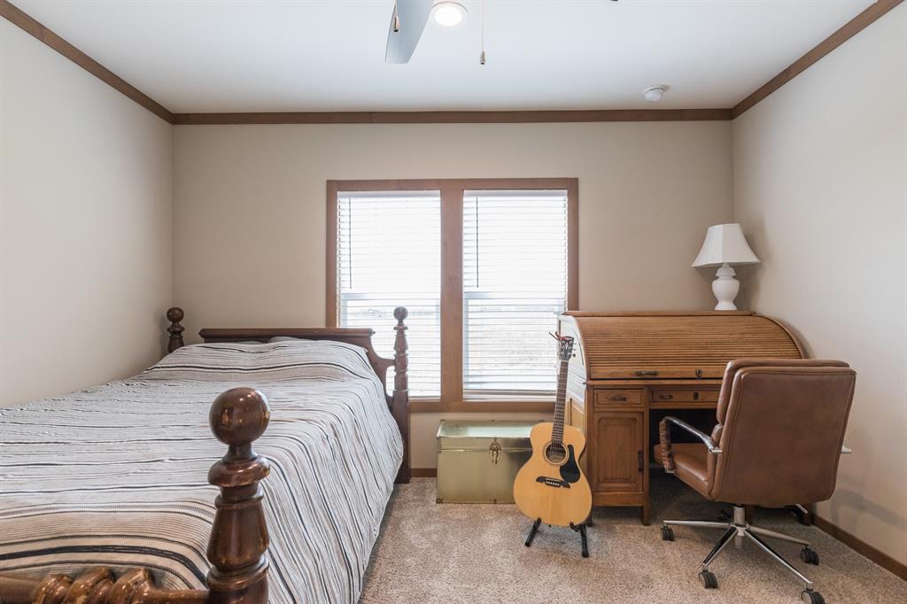 10099 County Road 452 Merkel, TX 79536 - Photo 24 of 28 a bedroom with a bed and a chair