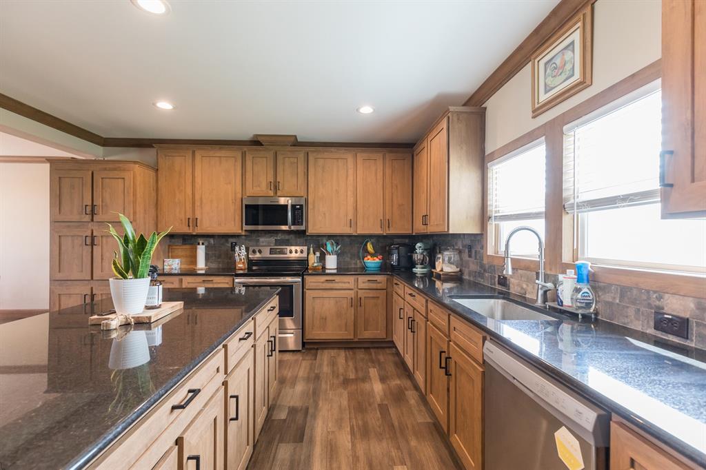 10099 County Road 452 Merkel, TX 79536 - Photo 5 of 28 a kitchen with a sink a counter top space appliances and cabinets