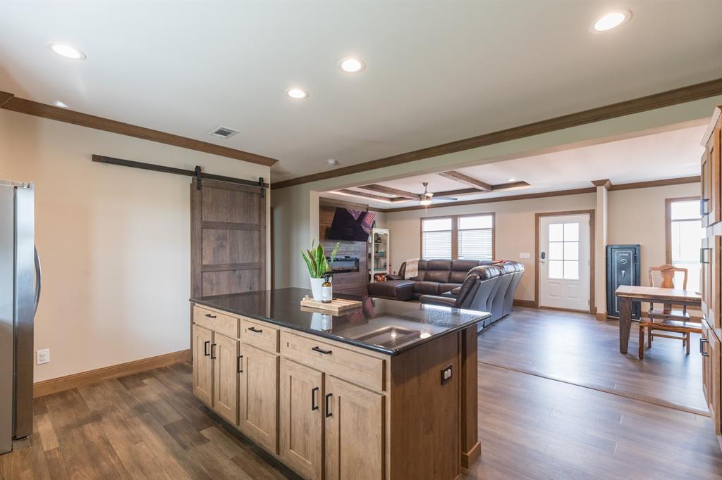 10099 County Road 452 Merkel, TX 79536 - Photo 6 of 28 a kitchen with stainless steel appliances granite countertop a sink stove and wooden floor