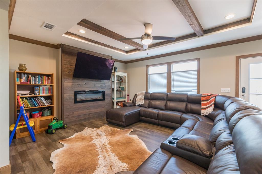 10099 County Road 452 Merkel, TX 79536 - Photo 10 of 28 a living room with furniture a flat screen tv and a fireplace