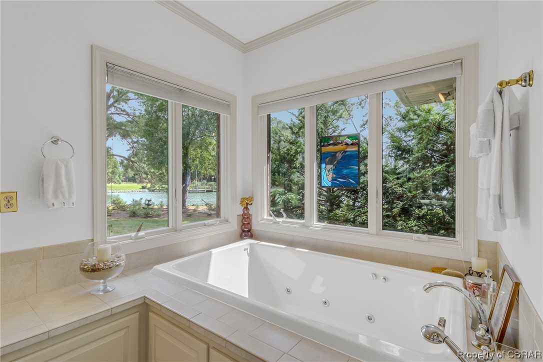 181 Duckbill Road White Stone, VA 22578 - Photo 31 of 50 Bathroom with crown molding, a relaxing tiled bath, and plenty of natural light