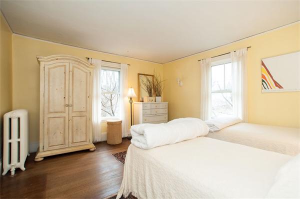 232 Edge Hill Road Milton, MA 02186 - Photo 19 of 23 a bedroom with a bed and wooden floor