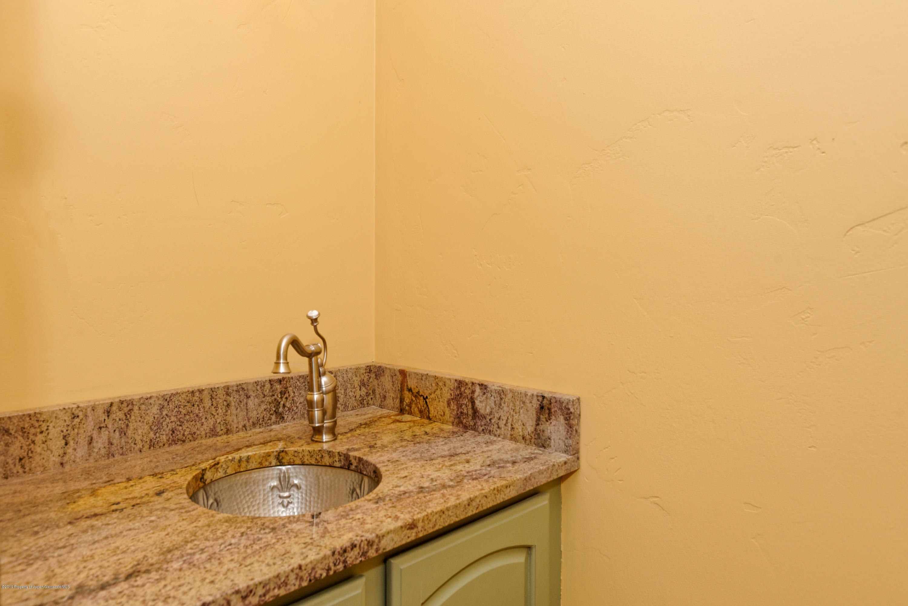 1371 Firethorn Drive Rifle, CO 81650 - Photo 11 of 16 a bathroom with a granite countertop sink and a mirror