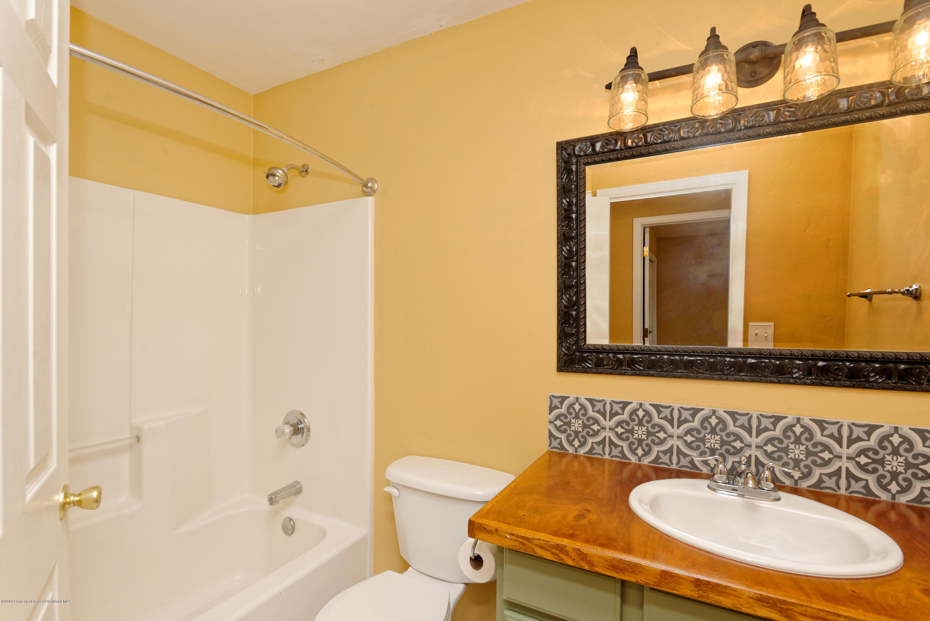 1371 Firethorn Drive Rifle, CO 81650 - Photo 12 of 16 a bathroom with a sink a toilet and shower