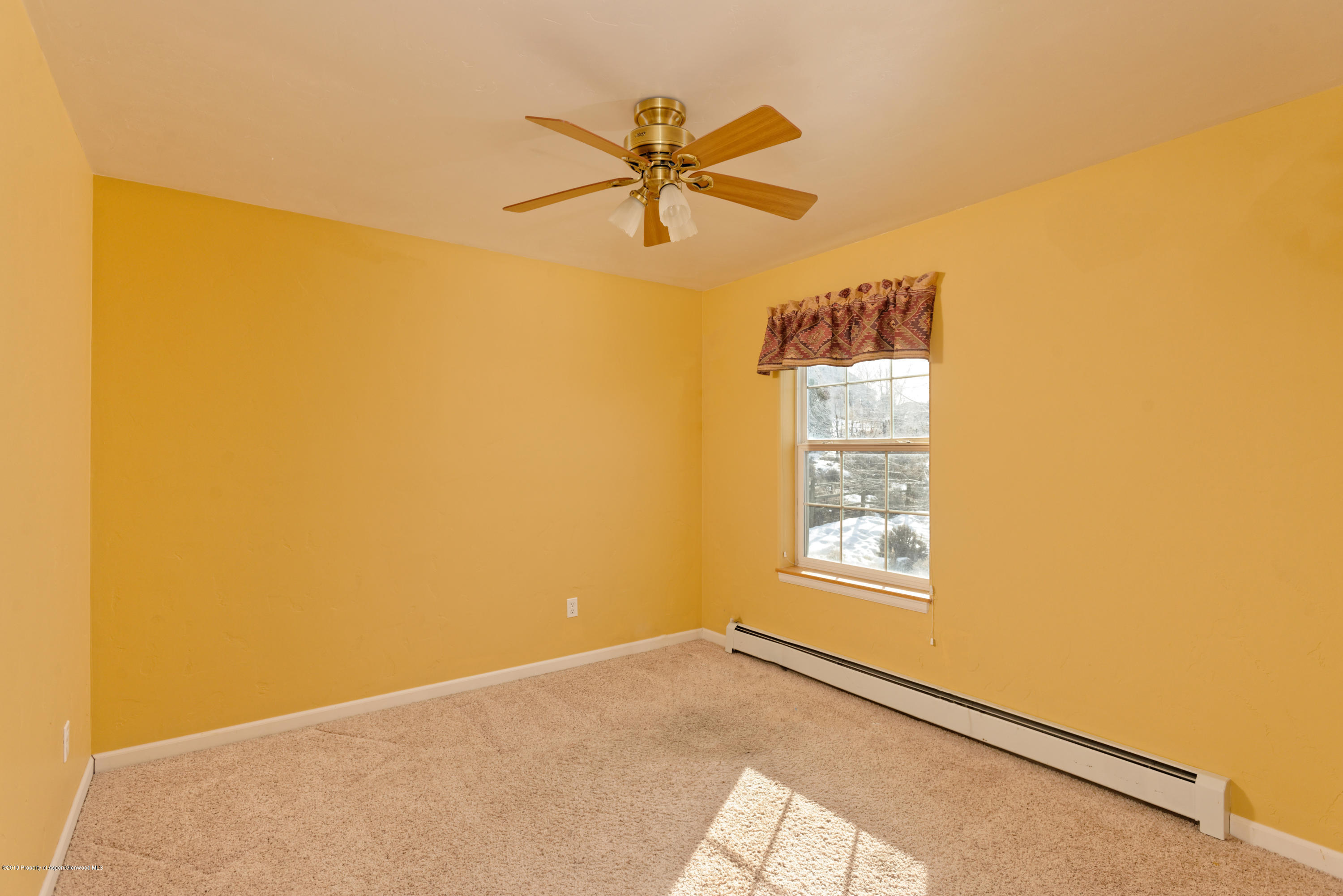 1371 Firethorn Drive Rifle, CO 81650 - Photo 13 of 16 a view of a big room with windows and chandelier fan