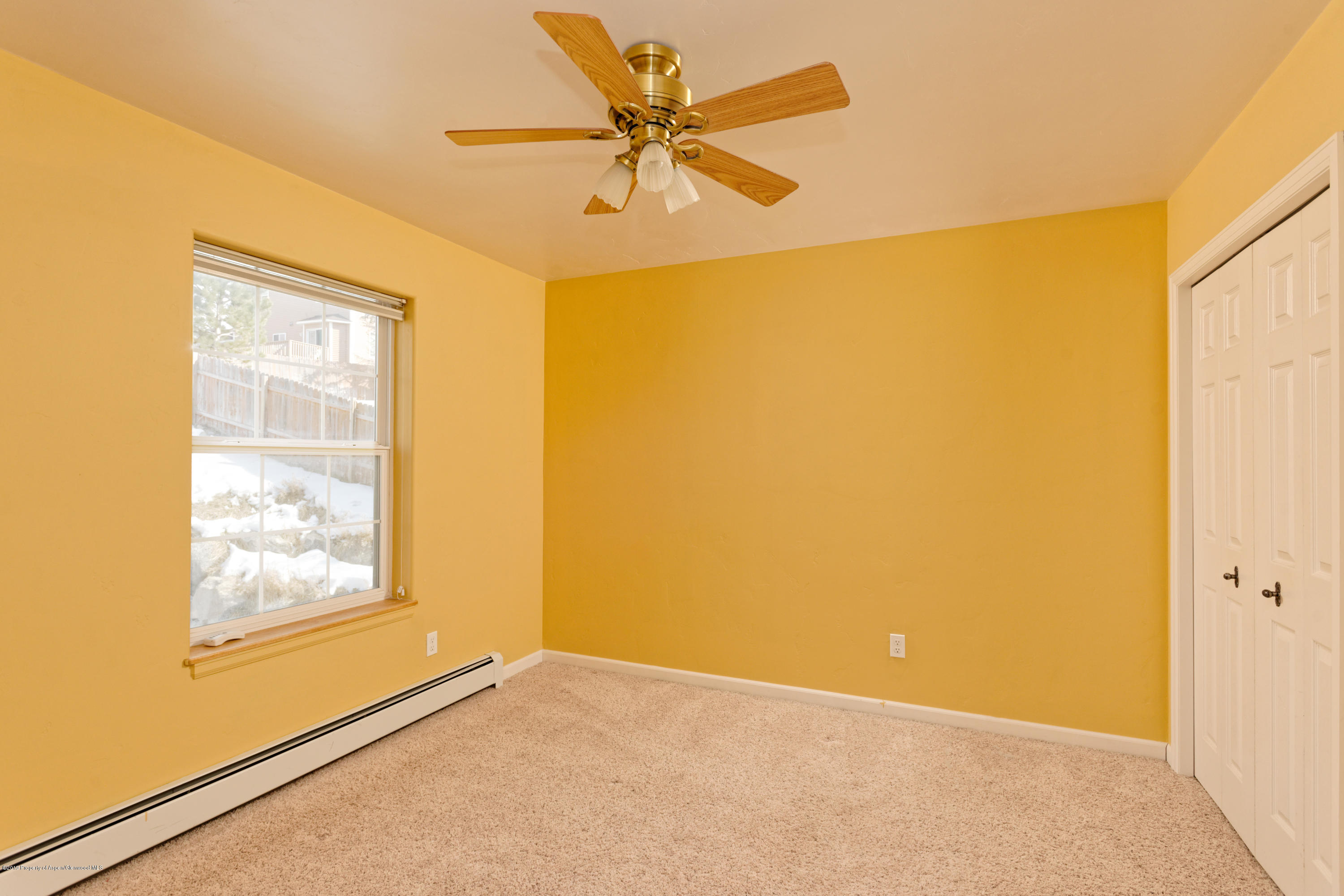 1371 Firethorn Drive Rifle, CO 81650 - Photo 14 of 16 an empty room with a window and a ceiling fan