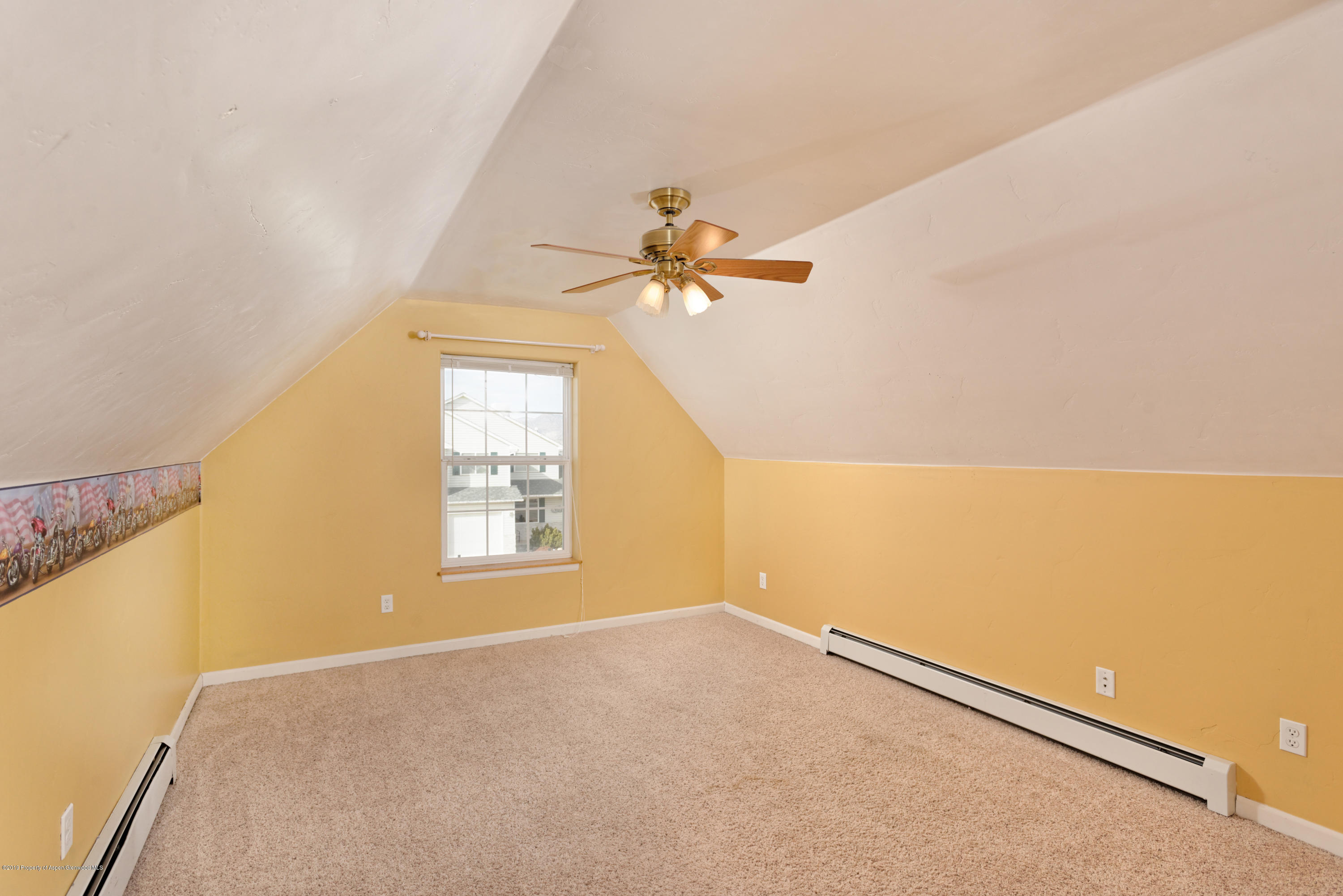 1371 Firethorn Drive Rifle, CO 81650 - Photo 4 of 16 a view of a big room with windows and chandelier fan