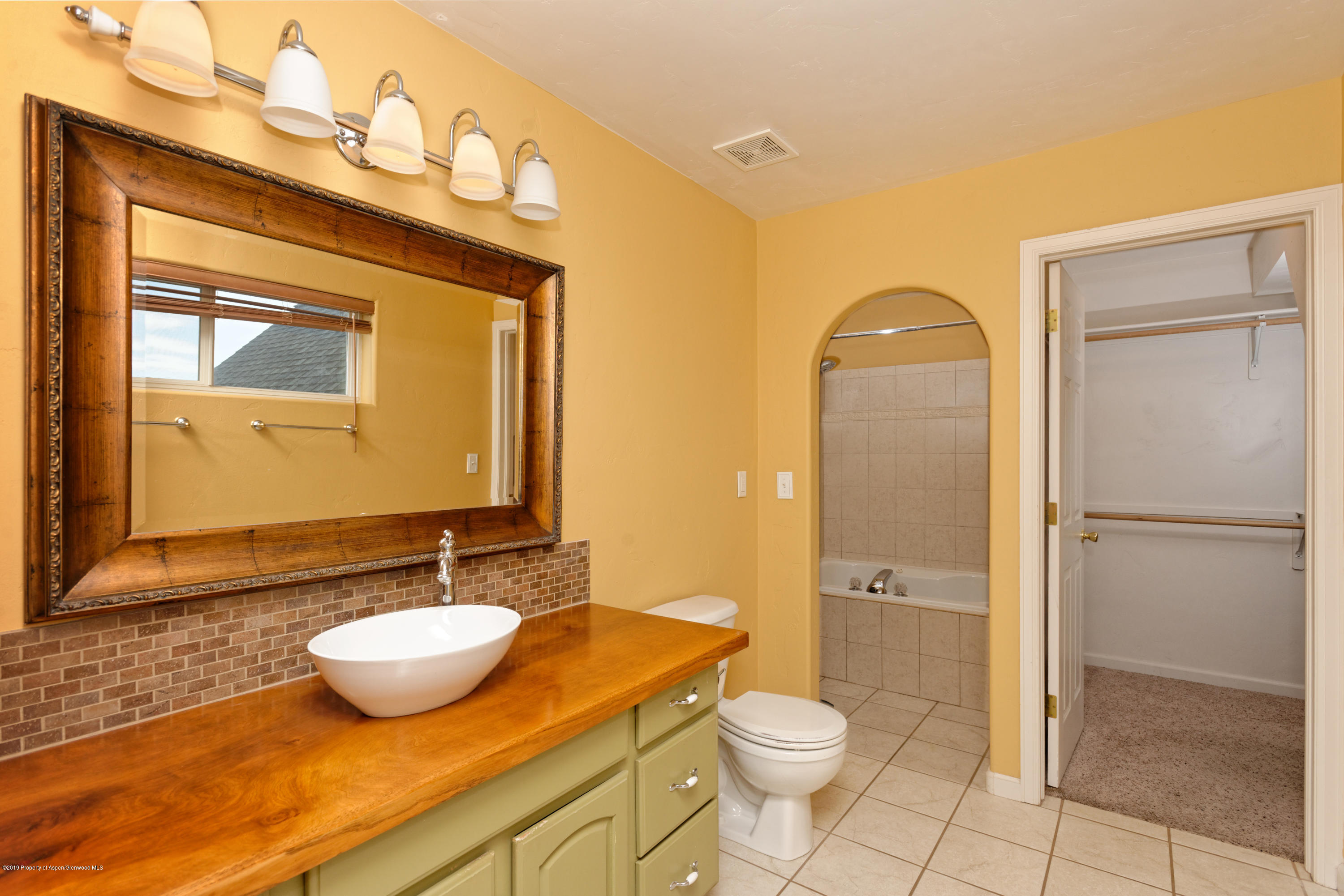 1371 Firethorn Drive Rifle, CO 81650 - Photo 6 of 16 a bathroom with a granite countertop sink toilet and shower