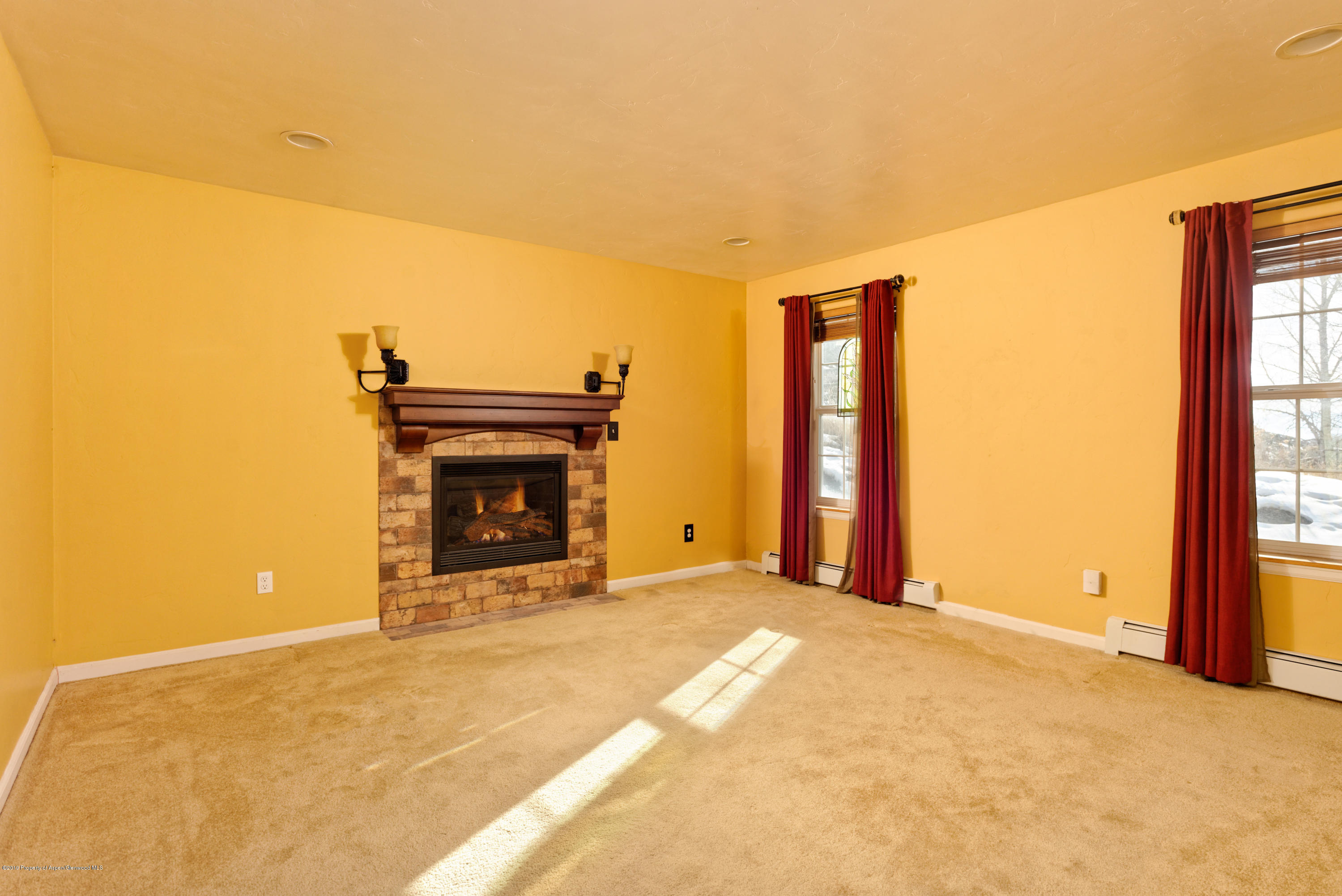 1371 Firethorn Drive Rifle, CO 81650 - Photo 7 of 16 a view of an empty room with a fireplace and a window