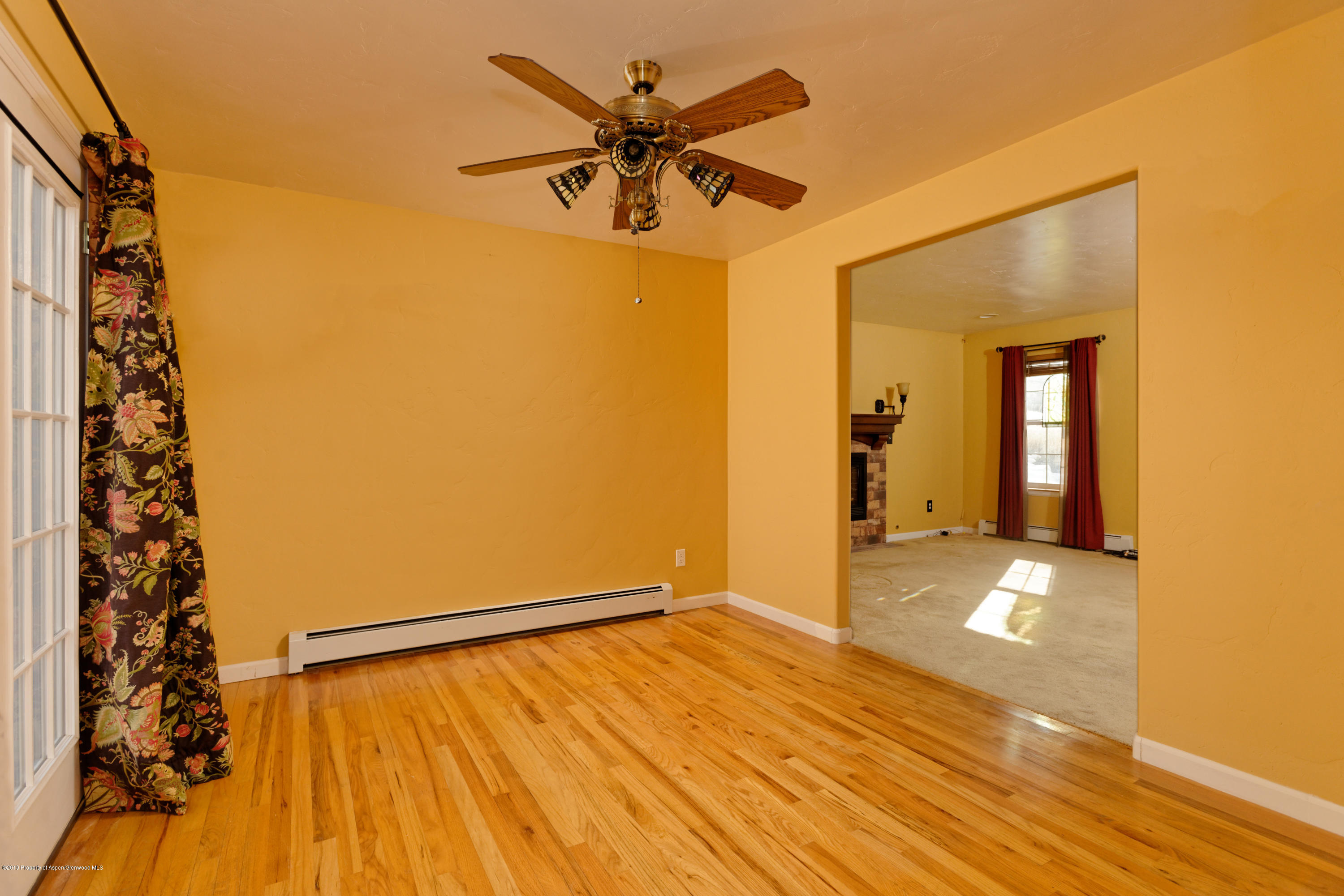 1371 Firethorn Drive Rifle, CO 81650 - Photo 10 of 16 a view of an empty room with window and wooden floor