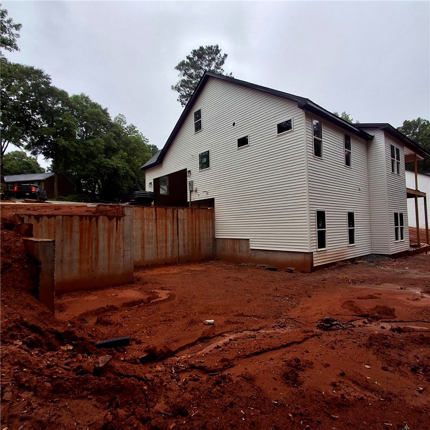 1411 Stonehurst Road Anderson, SC 29621 - Photo 2 of 3 Newly constructed home with fresh siding and a walk-out basement, ready for landscaping.