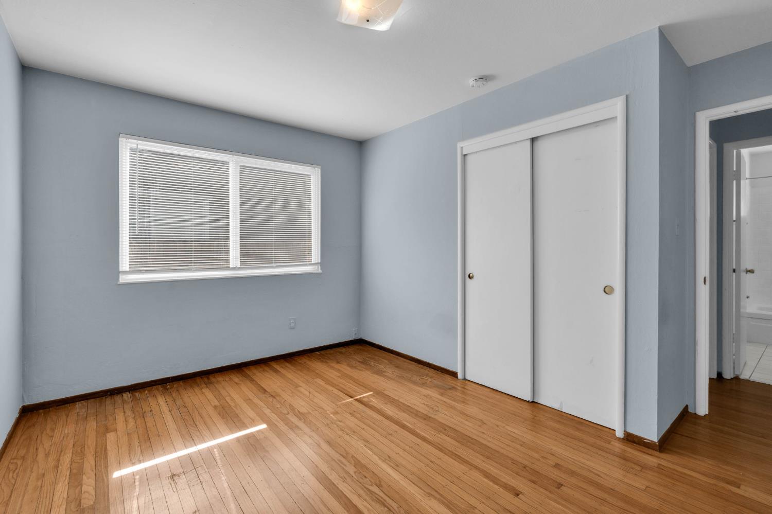 1714 Pole Line Road Davis, CA 95618 - Photo 11 of 24 a view of an empty room with wooden floor and a window