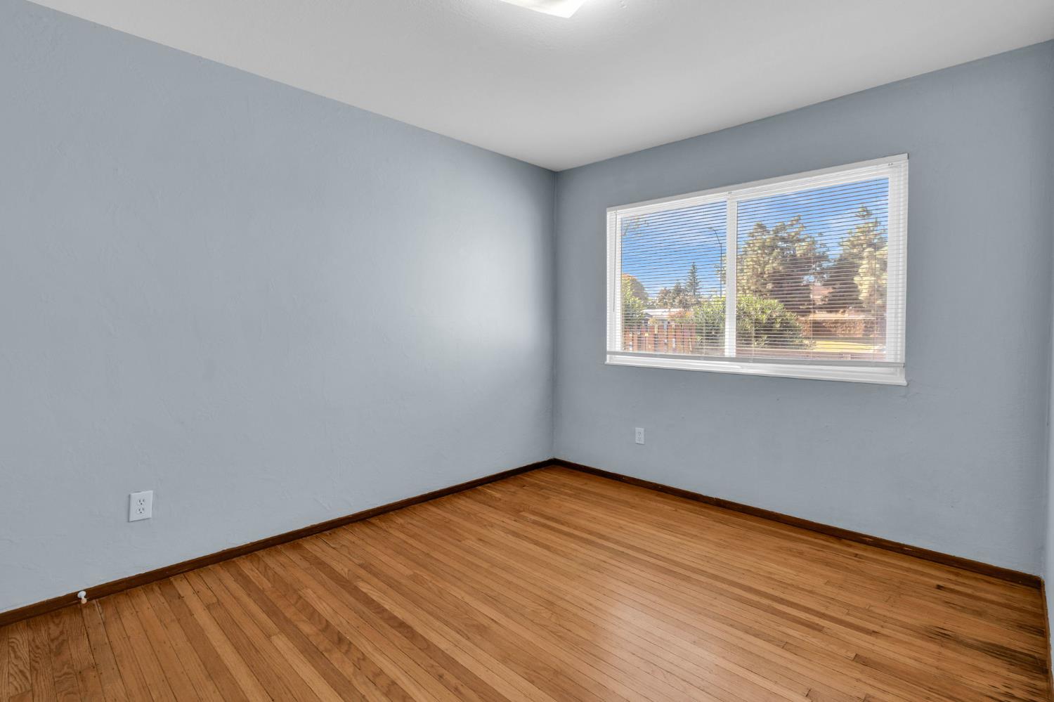 1714 Pole Line Road Davis, CA 95618 - Photo 15 of 24 a view of an empty room with wooden floor and a window