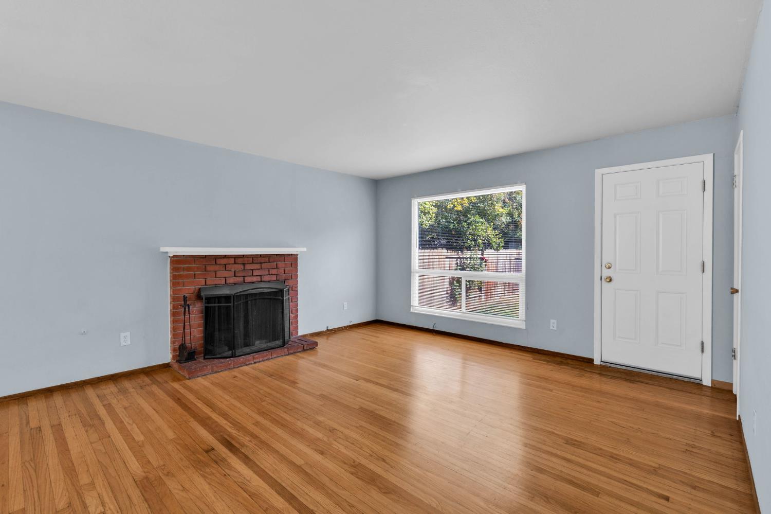 1714 Pole Line Road Davis, CA 95618 - Photo 3 of 24 a view of empty room with wooden floor and fireplace