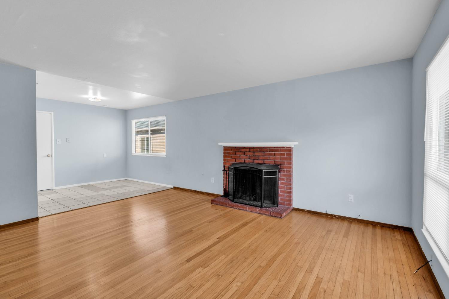 1714 Pole Line Road Davis, CA 95618 - Photo 4 of 24 a view of empty room with wooden floor and fireplace