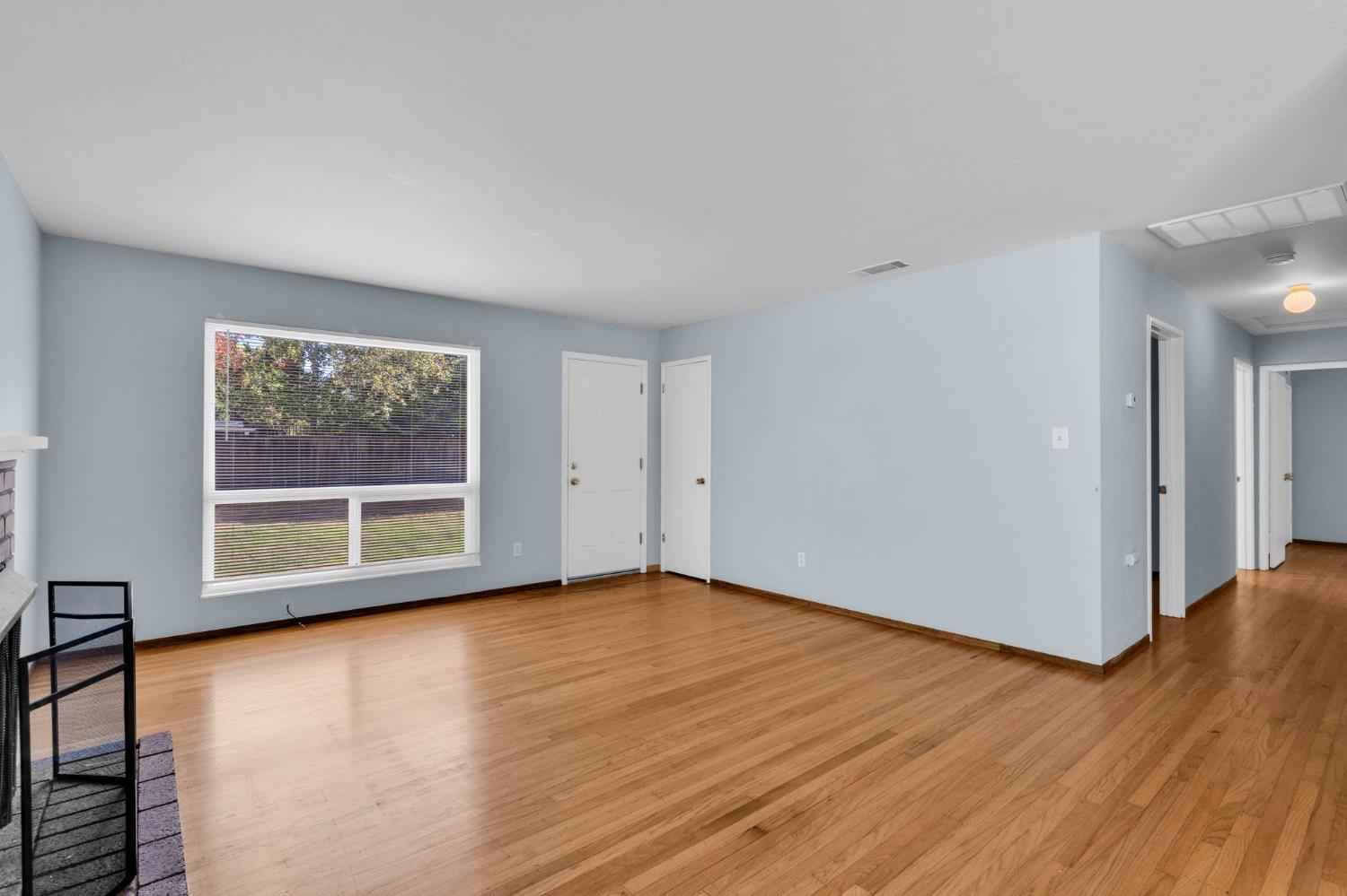 1714 Pole Line Road Davis, CA 95618 - Photo 6 of 24 a view of an empty room with wooden floor and a window