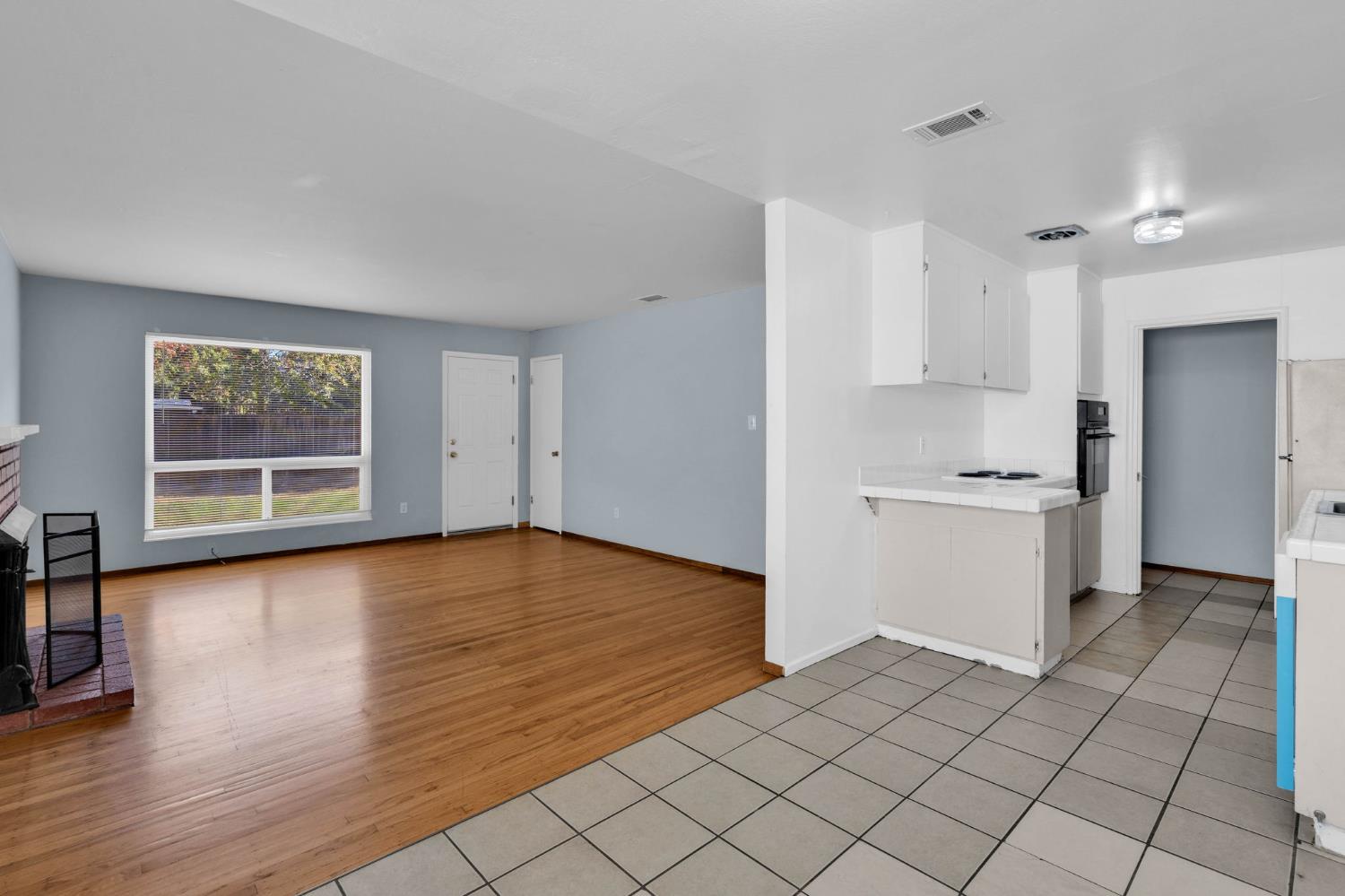 1714 Pole Line Road Davis, CA 95618 - Photo 7 of 24 a view of a kitchen with wooden floor and a window