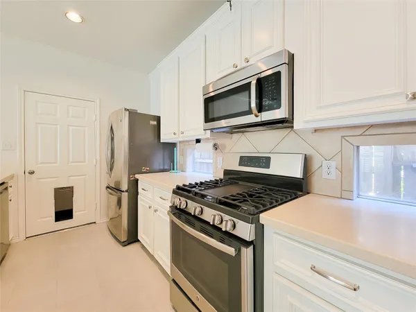 a kitchen with a stove microwave and refrigerator
