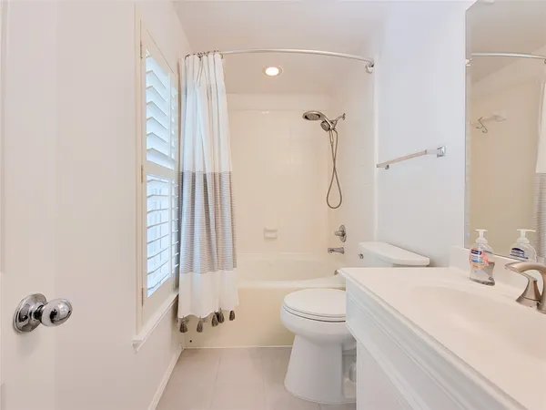 a bathroom with a granite countertop sink toilet a shower and a mirror
