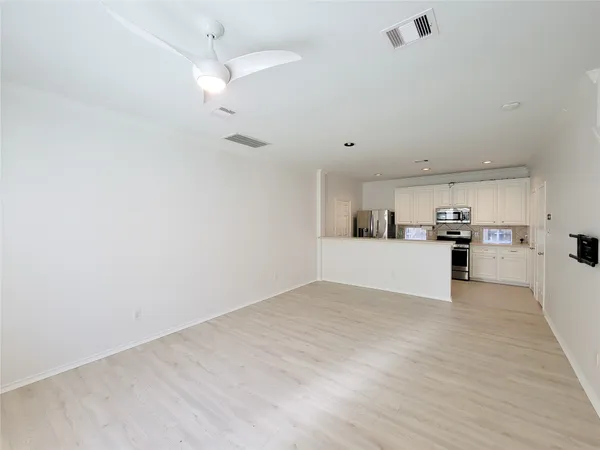 a view of a kitchen with a sink and cabinets