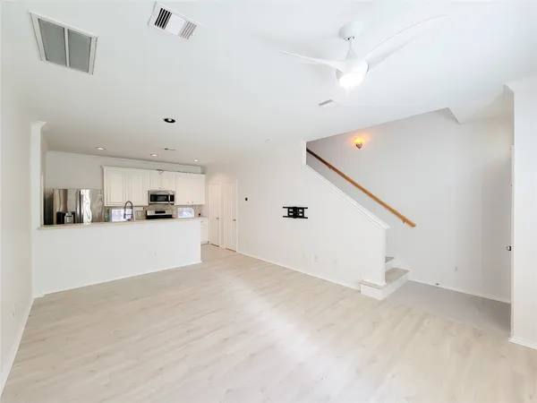 a view of a kitchen with microwave and cabinets
