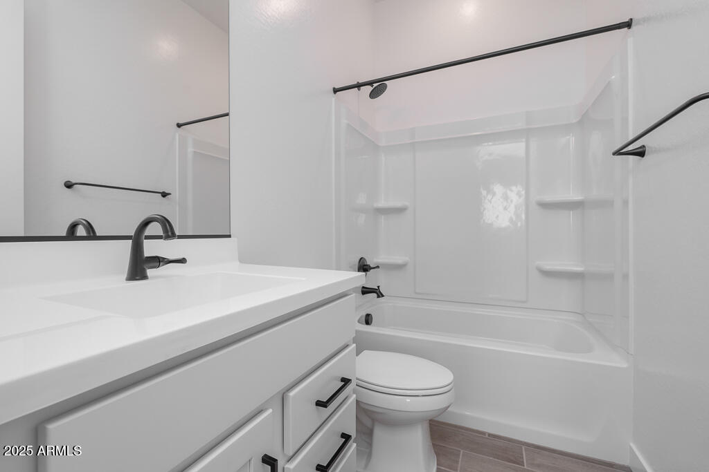 1946 East Empeltre Road San Tan Valley, AZ 85140 - Photo 13 of 19 a bathroom with a sink a toilet and a bathtub