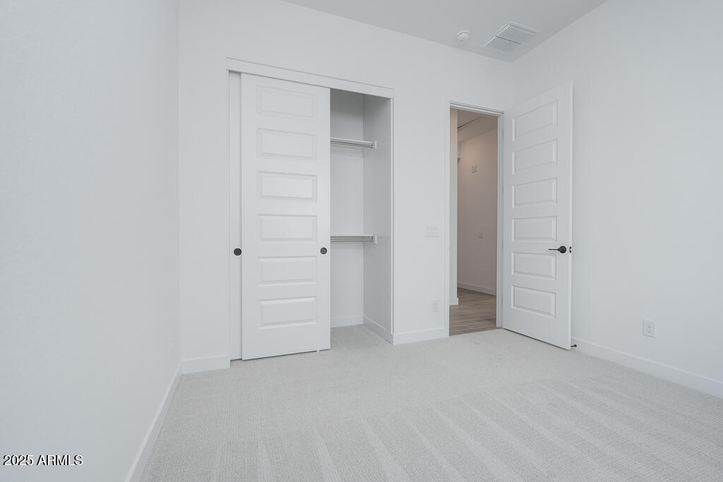 1946 East Empeltre Road San Tan Valley, AZ 85140 - Photo 15 of 19 wooden floor and closet in a room