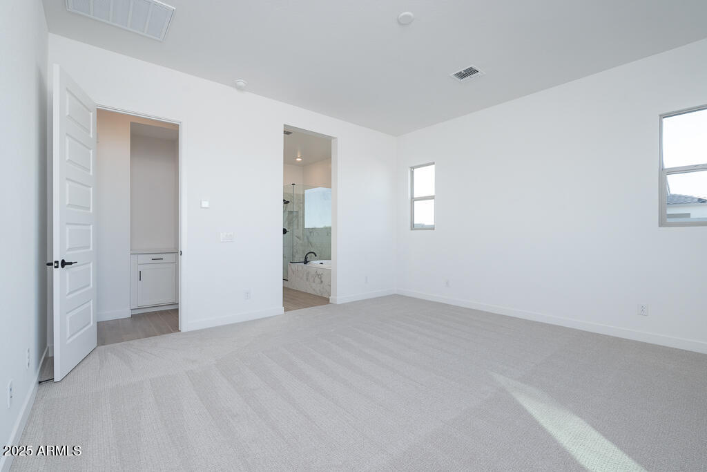 1946 East Empeltre Road San Tan Valley, AZ 85140 - Photo 8 of 19 a view of an empty room with a window