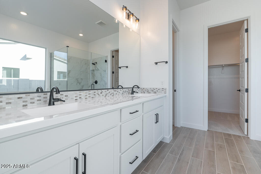 1946 East Empeltre Road San Tan Valley, AZ 85140 - Photo 9 of 19 a bathroom with double sink and a mirror