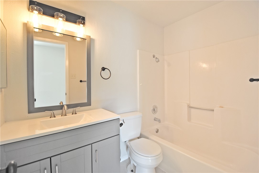 16813 Whitebrush Loop Austin, TX 78717 - Photo 15 of 22 a bathroom with a sink a toilet a shower and a mirror