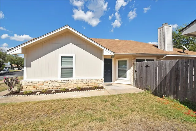 a front view of a house with a wooden fence