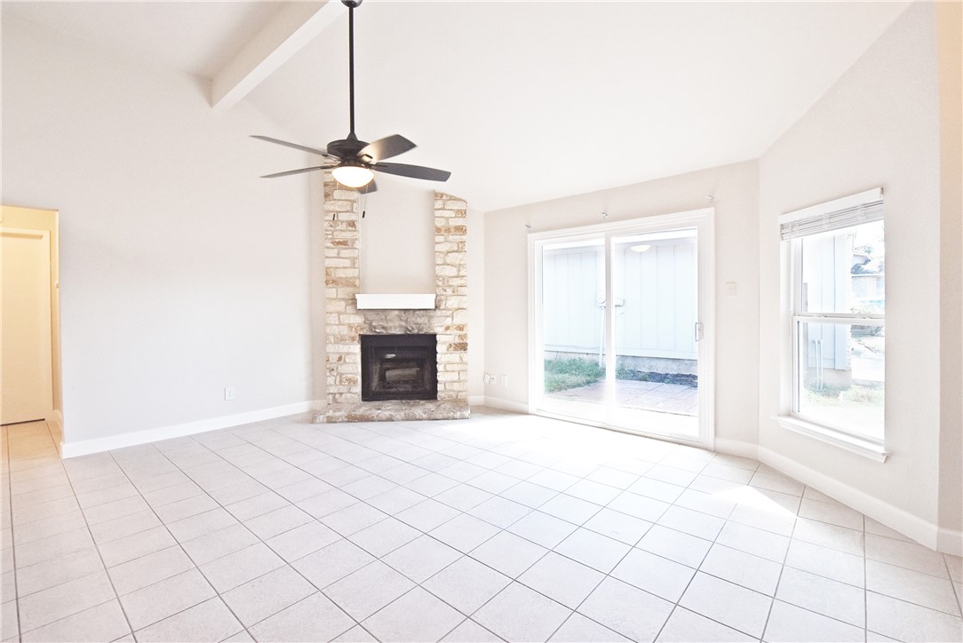 16813 Whitebrush Loop Austin, TX 78717 - Photo 5 of 22 a view of an empty room with a fireplace and a window
