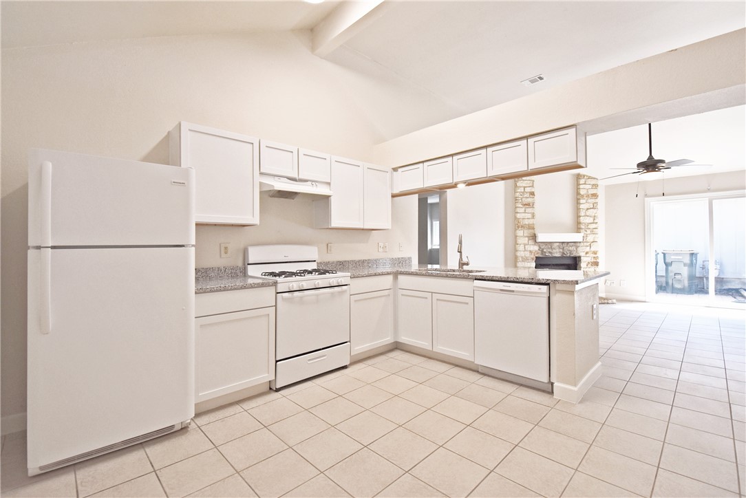 16813 Whitebrush Loop Austin, TX 78717 - Photo 6 of 22 a kitchen with white cabinets and white appliances