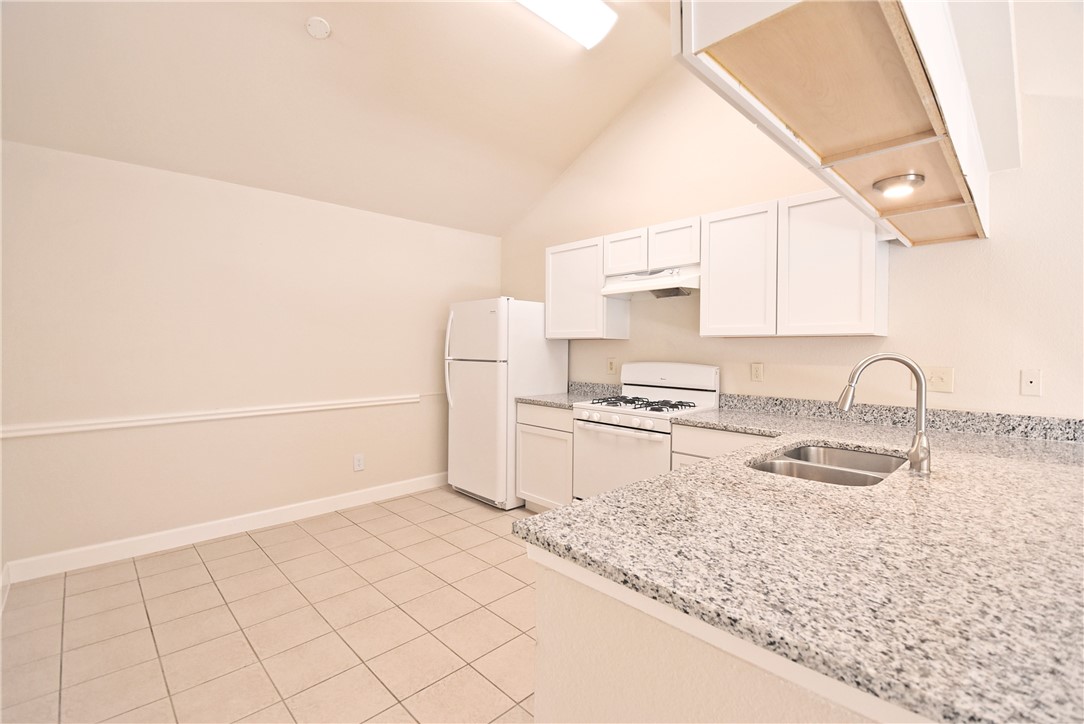 16813 Whitebrush Loop Austin, TX 78717 - Photo 7 of 22 a kitchen with granite countertop a sink and a stove top oven