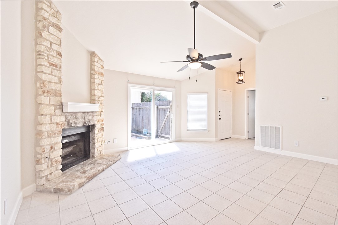 16813 Whitebrush Loop Austin, TX 78717 - Photo 8 of 22 a view of an empty room with a fireplace and a window
