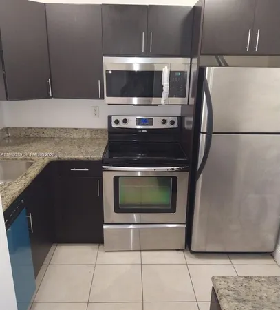 a kitchen with a stove microwave and refrigerator