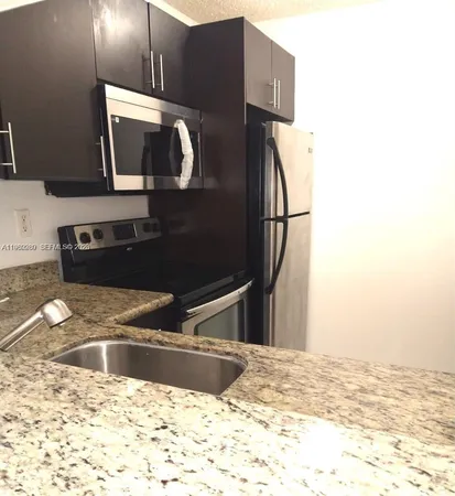 a view of a kitchen counter space and a sink