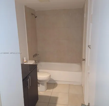 a bathroom with a granite countertop bathtub toilet and sink