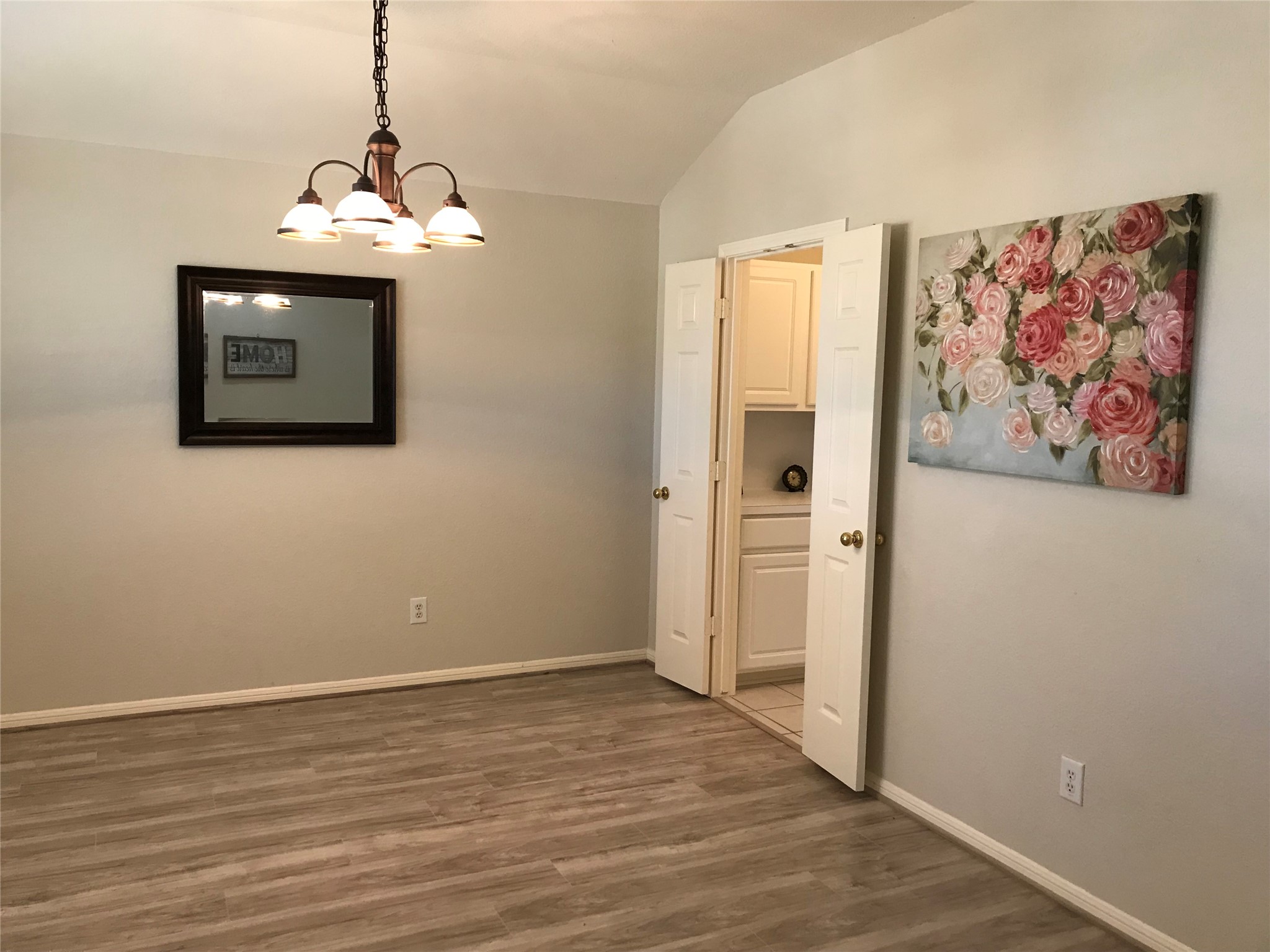 14615 Rochelle Court Cypress, TX 77429 - Photo 3 of 29 a view of a hallway with wooden floor and a chandelier