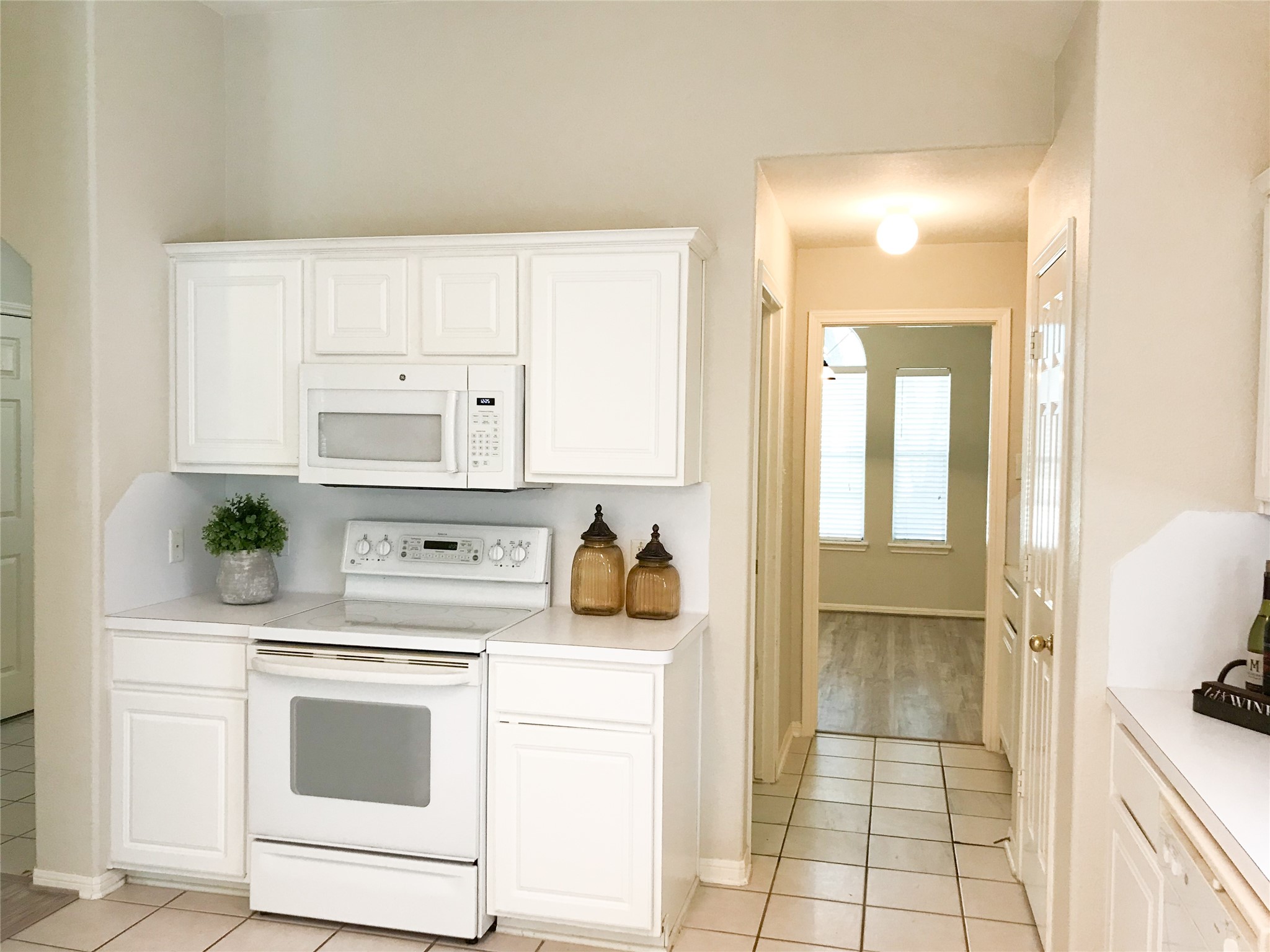 14615 Rochelle Court Cypress, TX 77429 - Photo 9 of 29 a kitchen with white cabinets and white appliances