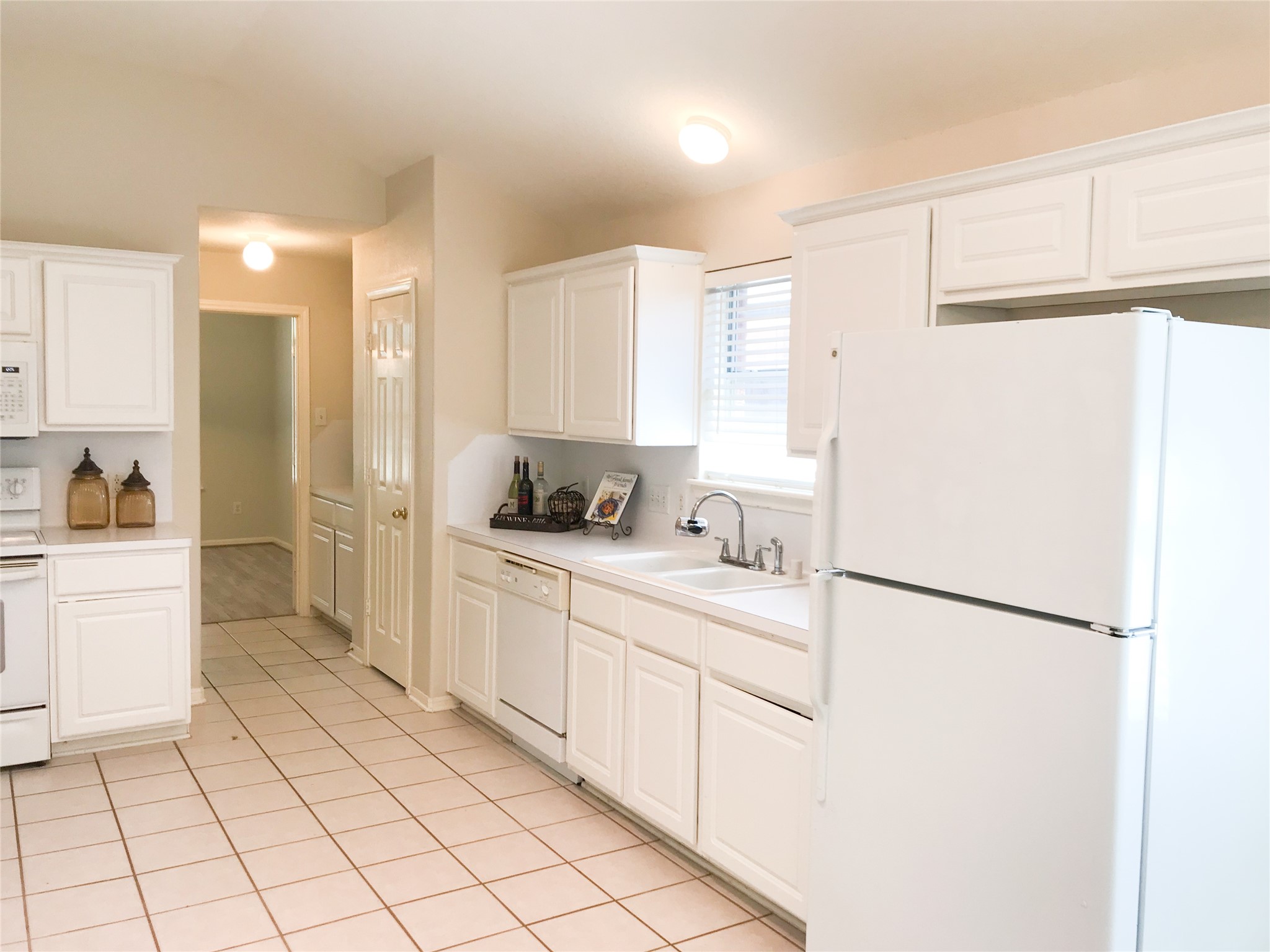 14615 Rochelle Court Cypress, TX 77429 - Photo 10 of 29 a kitchen with white cabinets and white appliances