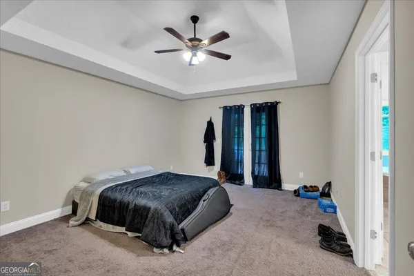 a bedroom with a bed and a ceiling fan
