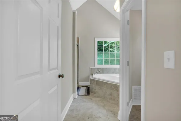 a bathroom with a bathtub and toilet
