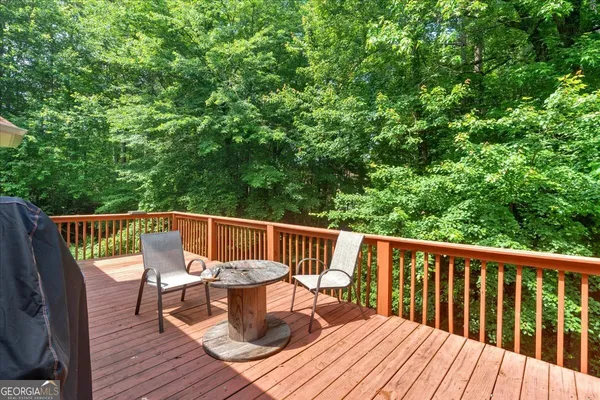 a view of balcony with furniture and wooden deck