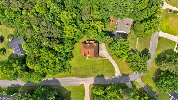 an aerial view of a house with a garden and swimming pool