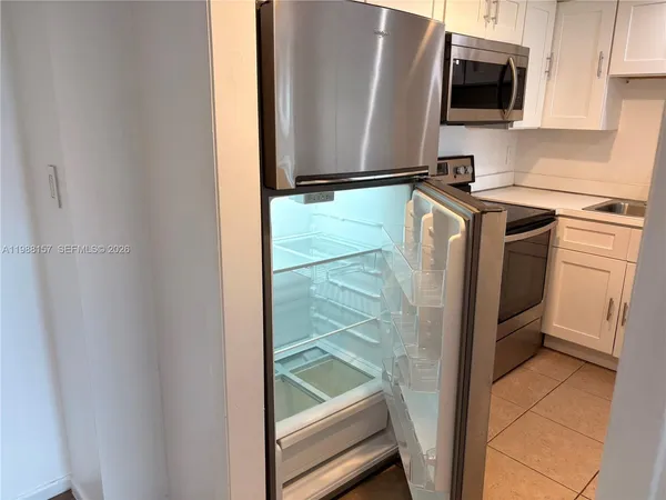 a kitchen with stainless steel appliances a refrigerator and a microwave
