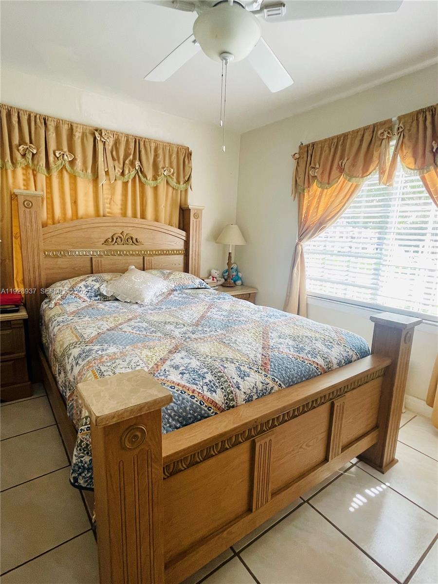 2045 Northwest 34th Street Miami, FL 33142 - Photo 11 of 12 a bedroom with a bed and window